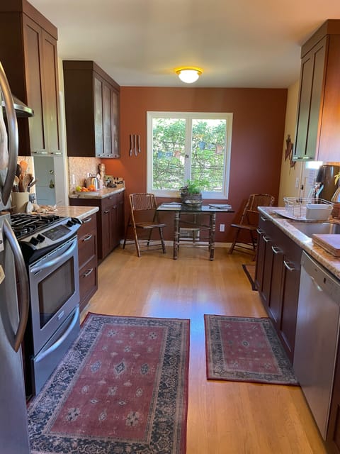 There's a lovely table by the front window, made private by variegated vines.