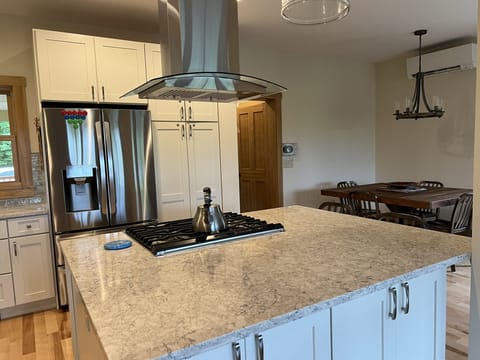 Kitchen with dining room table in background
