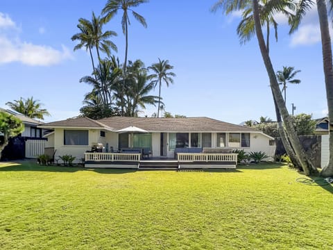 Enjoy classic island living in this charming beach cottage set on a spacious oceanfront lawn.
