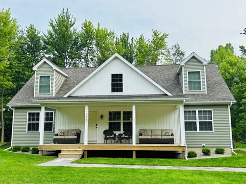 Third house from the bluff - with large driveway and spacious front porch. 