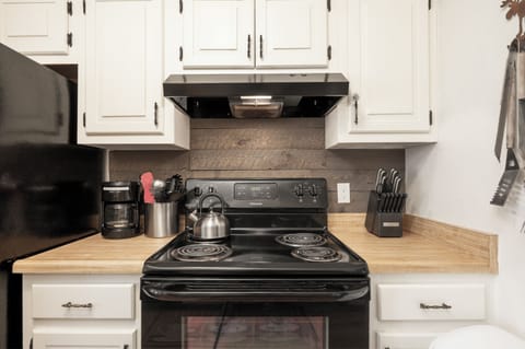 Your fully equipped kitchen awaits with modern appliances, butcher block counters, and everything you need to create memorable meals together.