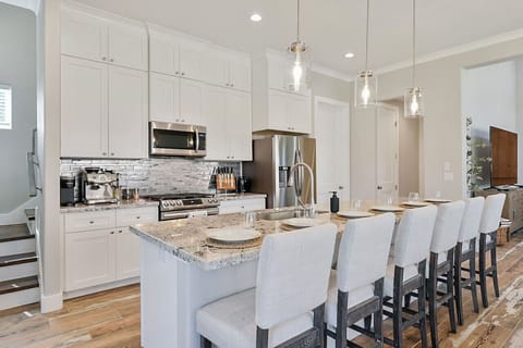 Ample bar seating for enhanced socializing and entertainment in kitchen.