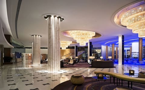 Step into a glamorous lobby glowing with crystal chandeliers.