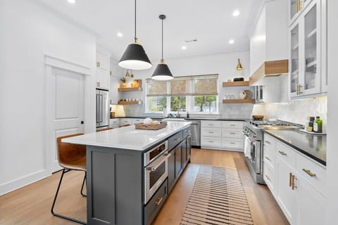 In the center of the room, you'll see our large kitchen island with four leather barstools.