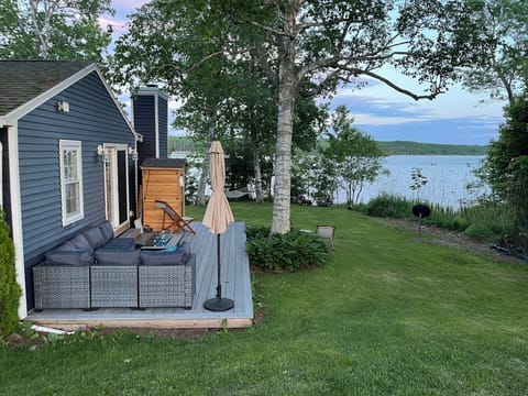 Deck overlooks a large yard and beautiful views of the ocean. 