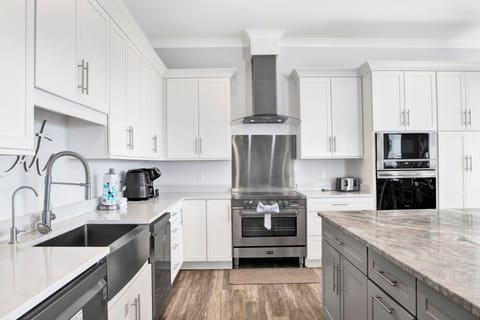 Fully equipped kitchen with dual appliances and stone counters