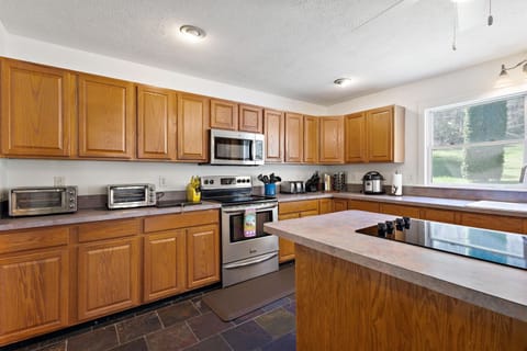 The kitchen features two refrigerators and two electric cooktops.