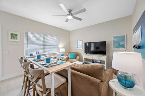 A bright and inviting open-concept area with a dining table, stylish décor, and cozy seating.