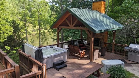 Hot tub overlooking the pond with wood burning fireplace