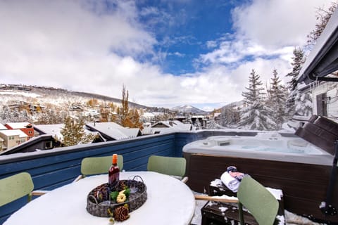 Snowy mountain escape with hot tub, wine, and stunning views.