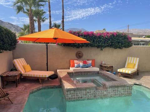 The property opens to the pool and hot tub in the front