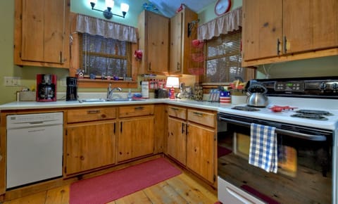 Fully equipped kitchen with modern appliances and charming wooden cabinets.