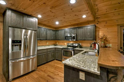 Modern kitchen with stainless steel appliances and granite countertops.