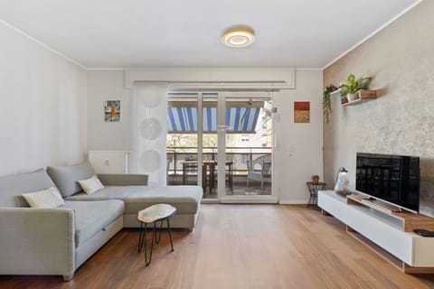 Sink into the comfortable sofa after exploring Luxembourg, with a serene balcony view and stylish interior.