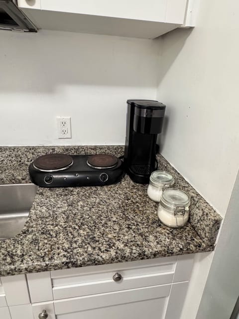 Hot plate for boiling or cooking in skillets. Free sugar and coffee (K cups).