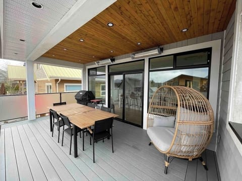 Covered and heated deck with bbq, burner, dining, and relaxing seating.