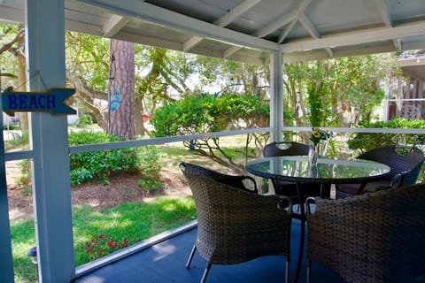 Screened in porch with outdoor dining area