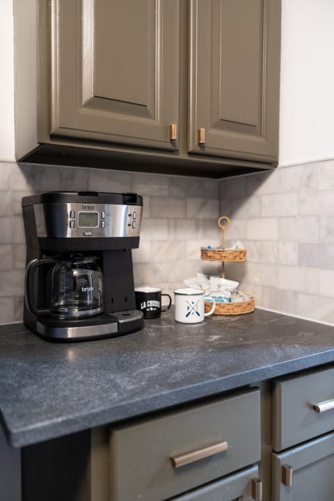 Coffee station stocked with regular and decaf grounds and pods.
