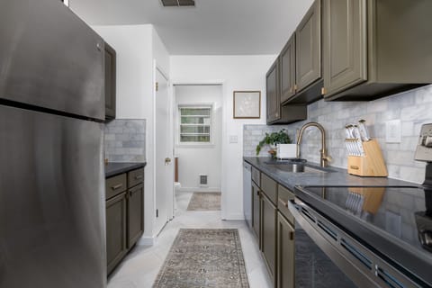 Kitchen with bathroom in background. 