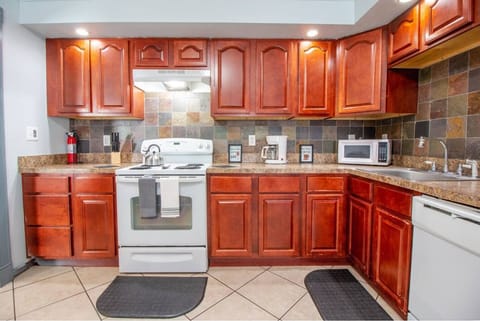 Kitchen with dark wood cabinets and a four-burner stove.
