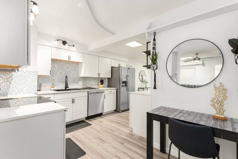 Modern and elegant kitchen with stainless steel appliances, marble countertops, and a cozy work nook