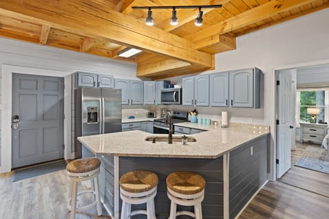 Granite countertops, bar with seating for 3. Kitchen is well stocked.