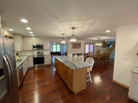 Kitchen and Dining room, with game room in the background.