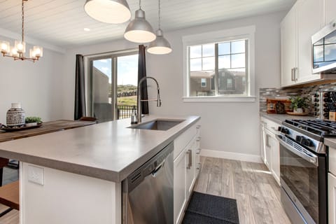 Fully Equipped Kitchen with Stainless Appliances Including a Gas Range