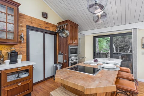 Modern high-end kitchen with Thermador & Wolf appliances with butcher block & marble island to make meals at home a joy!