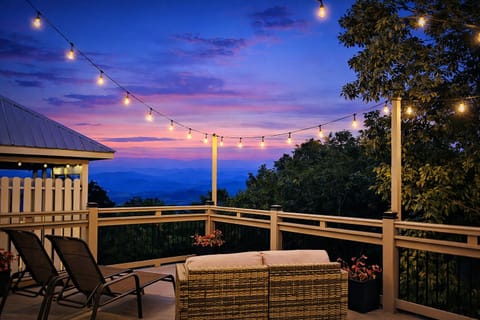 Upper deck with mt. views, string lights, and plenty of lounging options.  