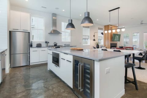 Walk in to an open floor plan, with a modern kitchen, living and dining space.