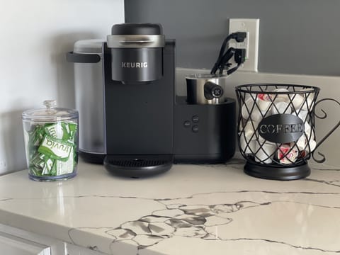 Keurig with coffee, sweetener and creamer