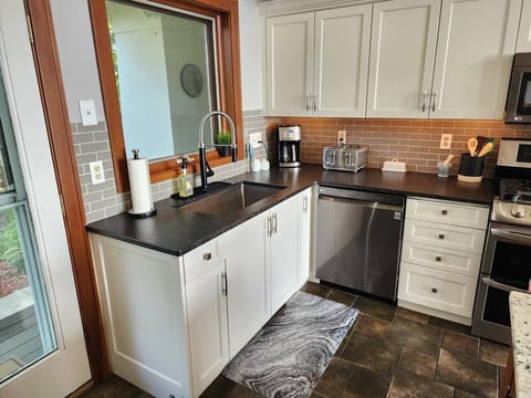 Kitchen is well stocked with a cofee maker, toaster, spices, plates, cups, silverware, etc!
