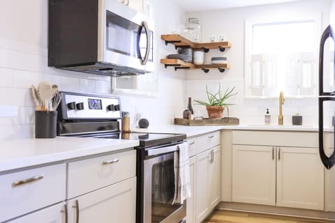 Fresh and clean kitchen with quartz countertops and tile backsplash 