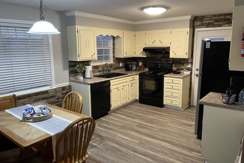 Fully stocked kitchen; additional table seating in family den.