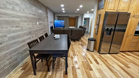 Dining area with table that seats 8 and can extend to accommodate up to 10. 