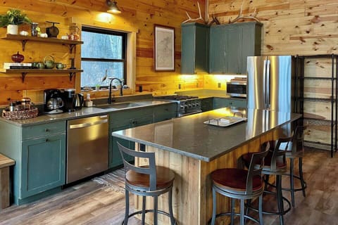 The gourmet kitchen has everything you'll need to enjoy meals in the cabin. The large kitchen island has seating for six.