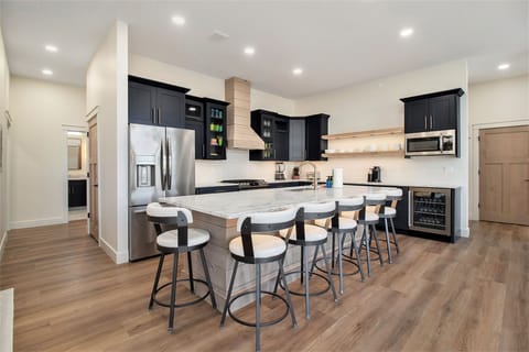 2nd floor the main kitchen island with 6 bar stools. 