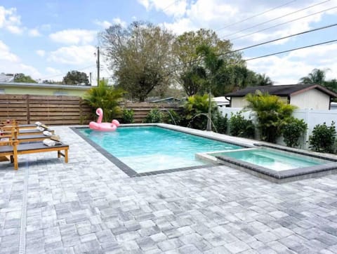 Heated pool and spa with brick patio all around