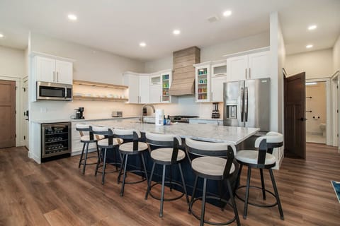 2nd floor the main kitchen island with 6 bar stools. 