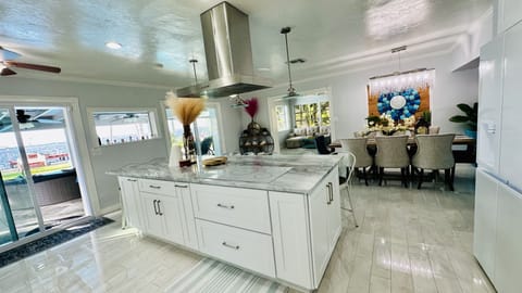 Island kitchen with seamless touchscreen induction cooktop. 