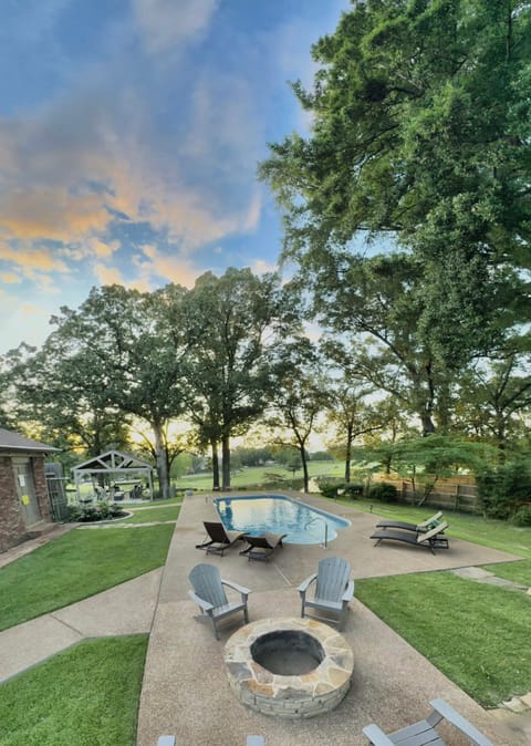 Firepit, pool and gazebo in backyard