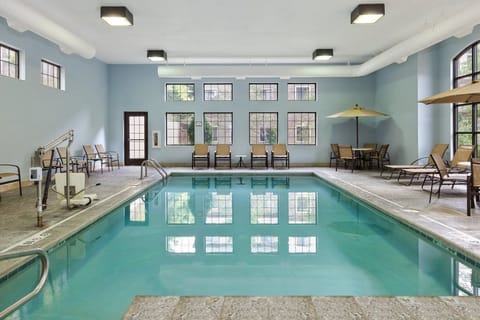 Unwind by the indoor pool, surrounded by comfortable seating and natural light.