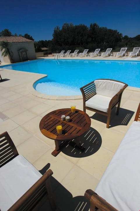 Lounge by the pristine pool under the sun in the summer months.