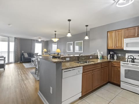 Step into your open-concept kitchen where granite countertops and modern appliances make meal prep effortless.