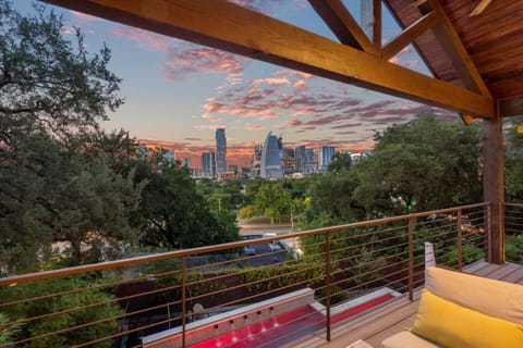 Best Views in Austin from the primary bedroom balcony couch and outdoor living.