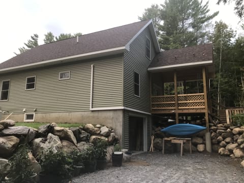 Rear porch/ stone walls. Garage.