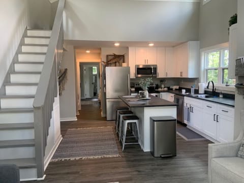 View from Front French Doors into Living Room/Kitchen/Up Stairs to Loft