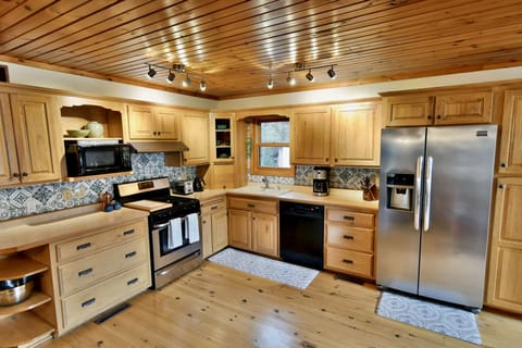 Our open-concept kitchen is fully stocked for making yummy meals for your group.