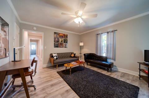 Comfortable living room with MId-Century Modern furniture, TV, and record player